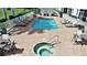 Community pool and spa with lounge chairs and seating at 17258 Acapulco Rd # 122, Punta Gorda, FL 33955
