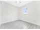 Simple bedroom with window and grey tile flooring at 2163 Blaser St, Punta Gorda, FL 33980