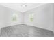 Bright bedroom with gray plank flooring and dual windows providing natural light at 2163 Blaser St, Punta Gorda, FL 33980