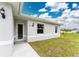 Front view of a light gray house with a walkway at 2163 Blaser St, Punta Gorda, FL 33980