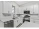 Modern kitchen featuring white cabinets, stainless steel appliances, and quartz countertops at 2163 Blaser St, Punta Gorda, FL 33980