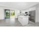 Contemporary kitchen with white cabinetry, stainless steel appliances, and a view of the backyard at 2163 Blaser St, Punta Gorda, FL 33980