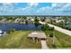 Aerial view of single-story home on waterfront lot with canal access at 2484 Broad Ranch Dr, Port Charlotte, FL 33948