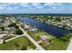 Aerial view showcasing home, pool, and large waterfront lot at 2484 Broad Ranch Dr, Port Charlotte, FL 33948