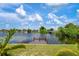 Serene waterfront backyard with private dock, lush landscaping, and access to canal at 2484 Broad Ranch Dr, Port Charlotte, FL 33948