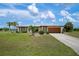 Single-story home with attached garage and landscaped yard at 2484 Broad Ranch Dr, Port Charlotte, FL 33948