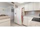 White kitchen cabinets and appliances, with granite countertops at 2484 Broad Ranch Dr, Port Charlotte, FL 33948