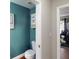 Small bathroom with teal walls and white fixtures at 2736 Suncoast Lakes Blvd, Punta Gorda, FL 33980