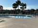 Relaxing community pool with lounge chairs and palm trees at 2736 Suncoast Lakes Blvd, Punta Gorda, FL 33980