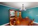 Dining room with hardwood floors, teal walls, and a built-in hutch at 2736 Suncoast Lakes Blvd, Punta Gorda, FL 33980