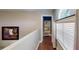 Bright and airy loft hallway with wood floors and built-in shelving at 2736 Suncoast Lakes Blvd, Punta Gorda, FL 33980