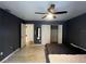 Bedroom with grey walls, a large bed, and access to a bathroom at 1405 Dorchester St, Port Charlotte, FL 33952