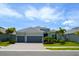 Two-story house with gray exterior and three-car garage at 25133 Longmeadow Dr, Punta Gorda, FL 33955