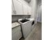 Bright laundry room with washer, dryer, and cabinets at 25133 Longmeadow Dr, Punta Gorda, FL 33955