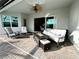 Relaxing covered patio with fire pit and comfortable seating at 25133 Longmeadow Dr, Punta Gorda, FL 33955