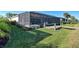 A lush green lawn leads to a screened-in lanai and private dock on a canal at 15240 Spanish Point Dr, Port Charlotte, FL 33981