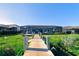 View of the backyard from a private dock showing the screened in lanai of the property at 15240 Spanish Point Dr, Port Charlotte, FL 33981