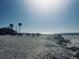 Picturesque beach scene with picnic tables and people enjoying the sunny weather near the ocean at 15240 Spanish Point Dr, Port Charlotte, FL 33981