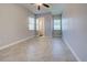 Spacious bedroom with tile flooring, neutral walls, and natural light from two windows at 15240 Spanish Point Dr, Port Charlotte, FL 33981