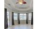 A versatile room with neutral tones, enhanced by a tray ceiling and wood look floors at 15240 Spanish Point Dr, Port Charlotte, FL 33981