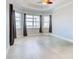 A versatile room with neutral tones, enhanced by a tray ceiling and tiled floors at 15240 Spanish Point Dr, Port Charlotte, FL 33981