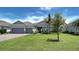 One-story home with gray siding, tile roof, and two-car garage at 15240 Spanish Point Dr, Port Charlotte, FL 33981