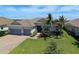 One-story home with tile roof, two-car garage, and landscaped lawn at 15240 Spanish Point Dr, Port Charlotte, FL 33981