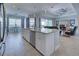 Open-concept kitchen featuring stainless steel appliances, a granite island, and a view into the adjacent living space at 15240 Spanish Point Dr, Port Charlotte, FL 33981