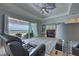 Living room with fireplace, ceiling fan, and patio access to outdoor pool at 15240 Spanish Point Dr, Port Charlotte, FL 33981