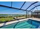 Covered pool area with an outdoor waterfront view and dock access at 15240 Spanish Point Dr, Port Charlotte, FL 33981