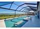 Enjoy this covered pool with a scenic view of the waterfront and dock, perfect for relaxation and entertainment at 15240 Spanish Point Dr, Port Charlotte, FL 33981