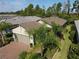 One-story house with tile roof, palm trees, and a brick driveway at 2555 Brassica Dr, North Port, FL 34289