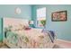 Bright bedroom with a floral comforter and white headboard at 2555 Brassica Dr, North Port, FL 34289