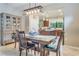 Dining room with wooden table, view into the kitchen at 2555 Brassica Dr, North Port, FL 34289