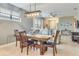 Dining area with a long wooden table and a rustic chandelier at 2555 Brassica Dr, North Port, FL 34289