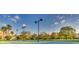 Well-lit tennis courts surrounded by trees at 2555 Brassica Dr, North Port, FL 34289