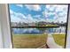 Stunning backyard view of the canal, docks, and waterfront homes under a beautiful blue sky at 56 Colony Point Dr, Punta Gorda, FL 33950