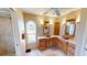 Bright bathroom featuring dual vanities, decorative vessel sinks, a frosted window and tiled floors at 56 Colony Point Dr, Punta Gorda, FL 33950