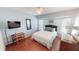 Bright bedroom featuring a ceiling fan, wood flooring, and a comfortable queen-sized bed at 56 Colony Point Dr, Punta Gorda, FL 33950