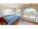 Bedroom features arched windows with outside views and hardwood flooring at 56 Colony Point Dr, Punta Gorda, FL 33950