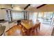 Dining room with terracotta tile flooring, built-in cabinets, a wooden table with seating for eight, and access to the lanai at 56 Colony Point Dr, Punta Gorda, FL 33950