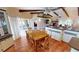 Cozy dining room featuring terracotta tile flooring, wooden table with seating for eight, and vaulted ceiling with exposed beams at 56 Colony Point Dr, Punta Gorda, FL 33950