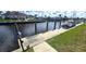 Dock on the waterfront canal with lush landscapes and luxury homes in the background at 56 Colony Point Dr, Punta Gorda, FL 33950