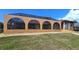 Charming screened-in patio featuring arched openings and a lush green lawn, perfect for enjoying the outdoors at 56 Colony Point Dr, Punta Gorda, FL 33950