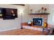 Close-up of the living room fireplace with colorful tile and mantle decor at 56 Colony Point Dr, Punta Gorda, FL 33950