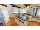 Functional kitchen space including an island cooktop and plenty of counter space at 56 Colony Point Dr, Punta Gorda, FL 33950