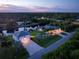 Night aerial view of a waterfront home with a detached garage at 1025 Cheshire St, Port Charlotte, FL 33953