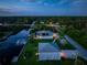 Night aerial view of waterfront home with pool and dock at 1025 Cheshire St, Port Charlotte, FL 33953