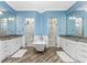 Elegant Primary bathroom with double vanities, soaking tub, and walk-in shower at 1025 Cheshire St, Port Charlotte, FL 33953