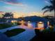 Evening view of a two-story house with a three-car garage and a large driveway at 1025 Cheshire St, Port Charlotte, FL 33953